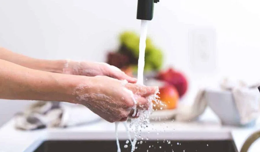 Person washing hands under running water, representing compulsive behavior—Doctors for Online OCD Treatment, Therapy & Counselling in India