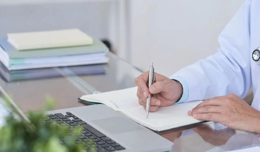 Psychiatric consultation with doctor prescribing medication at desk