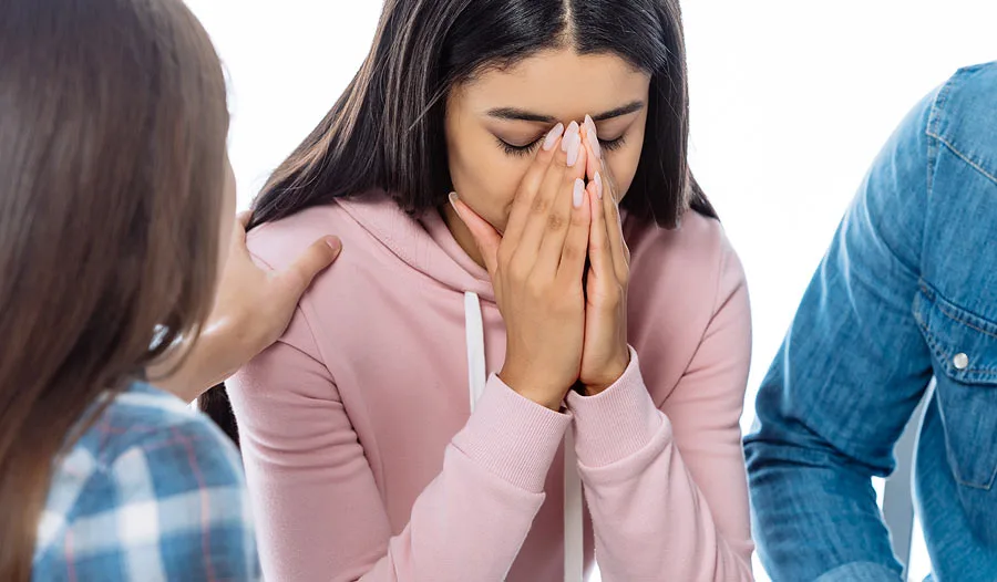 Teen girl receiving emotional support during a mental health counselling session